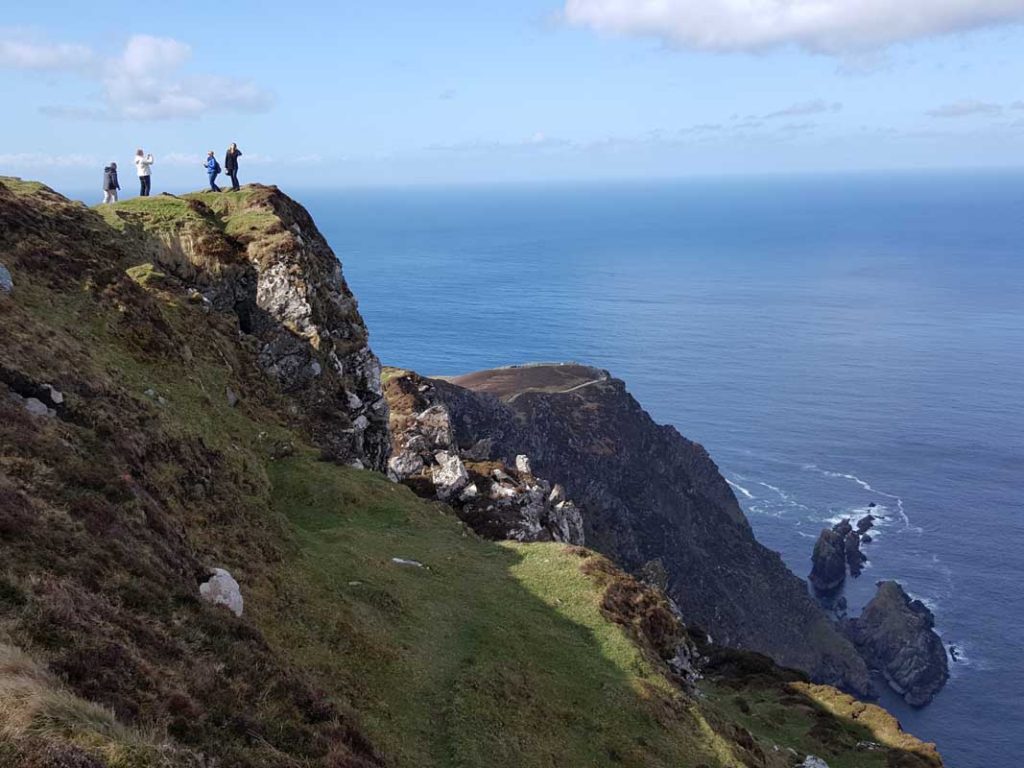 People posing near a cliff