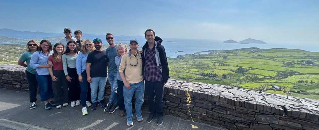 A group of people with the Skellig Islands in the background