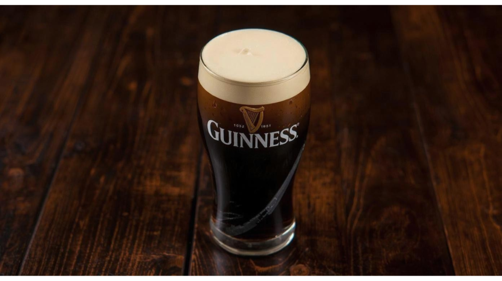 Pint of Guinness poured in a traditional pub, representing Irish pub culture.