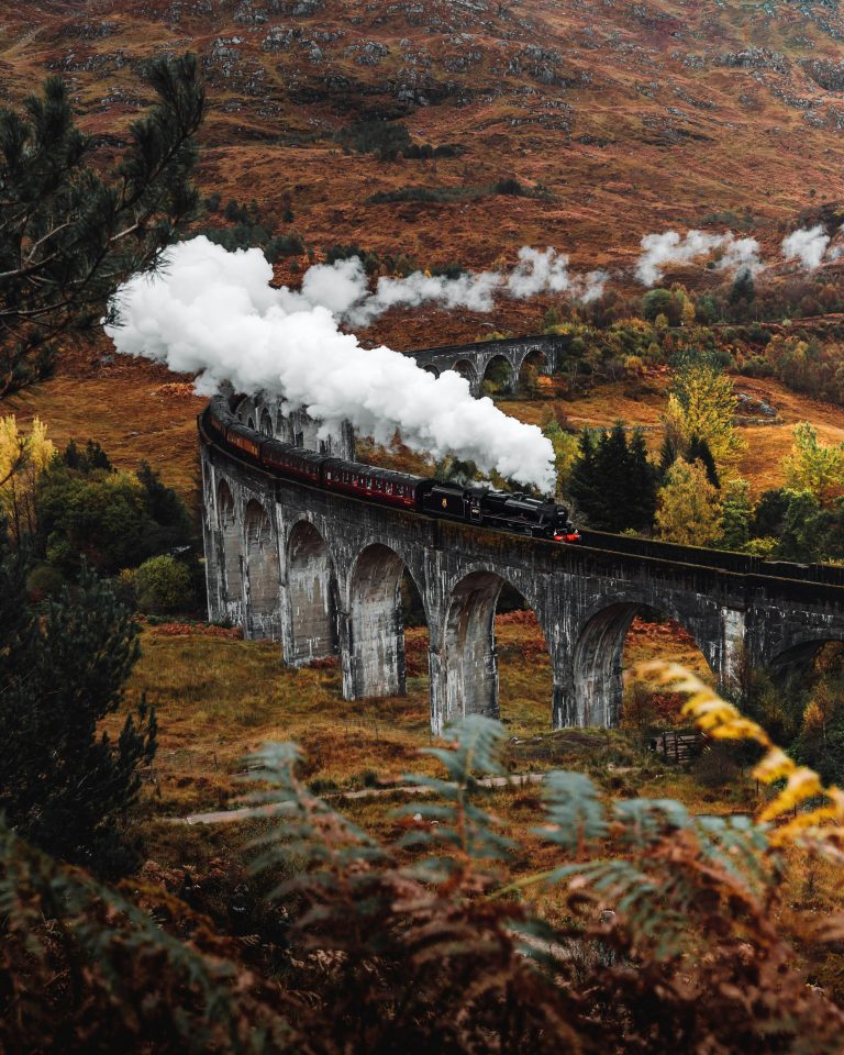 Steam train crossing Glenvinnan Viaduct