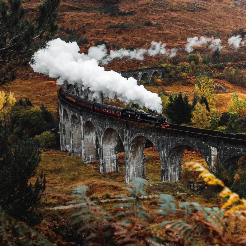 Steam train crossing Glenvinnan Viaduct